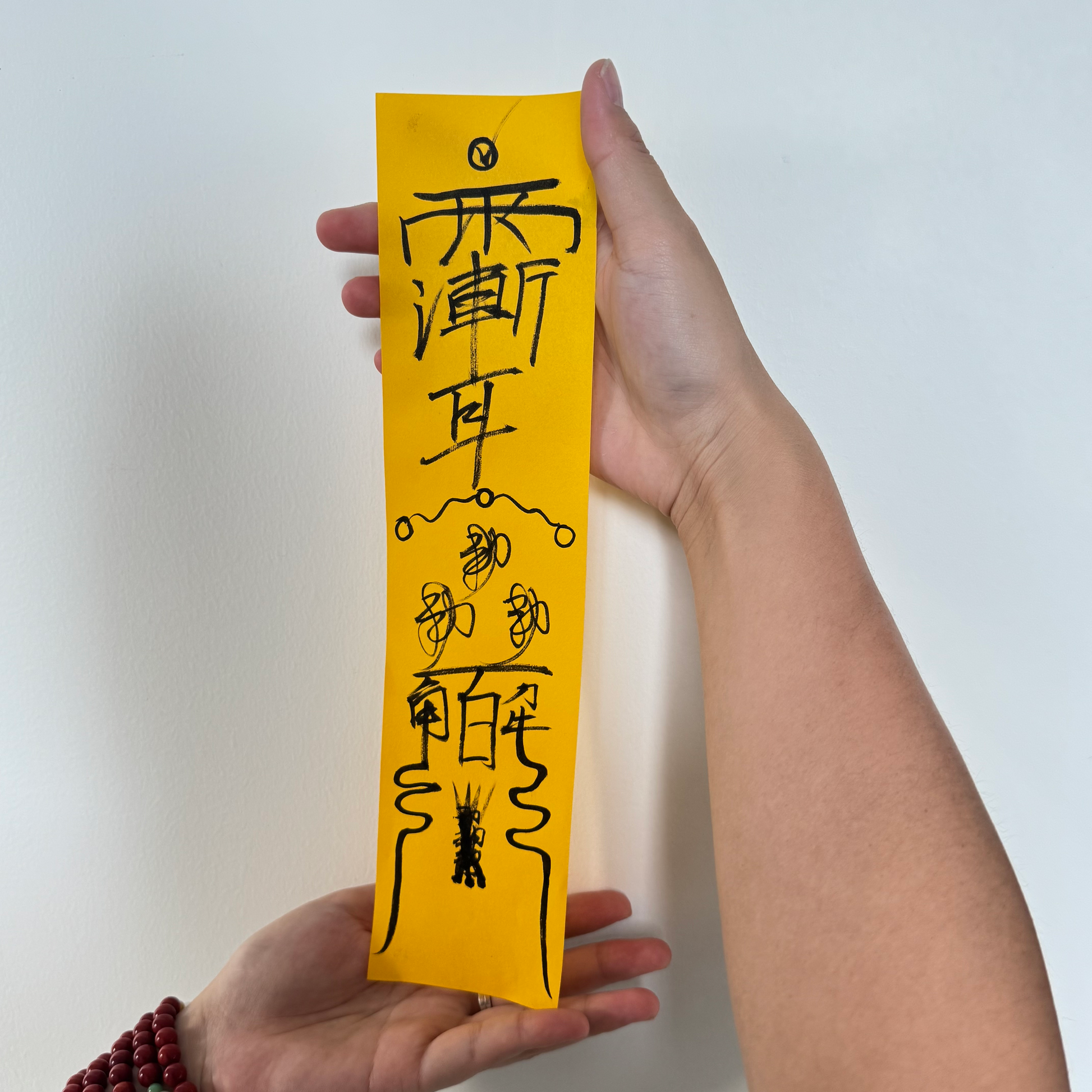 Hand-drawn Taoist talismans on yellow ritual paper