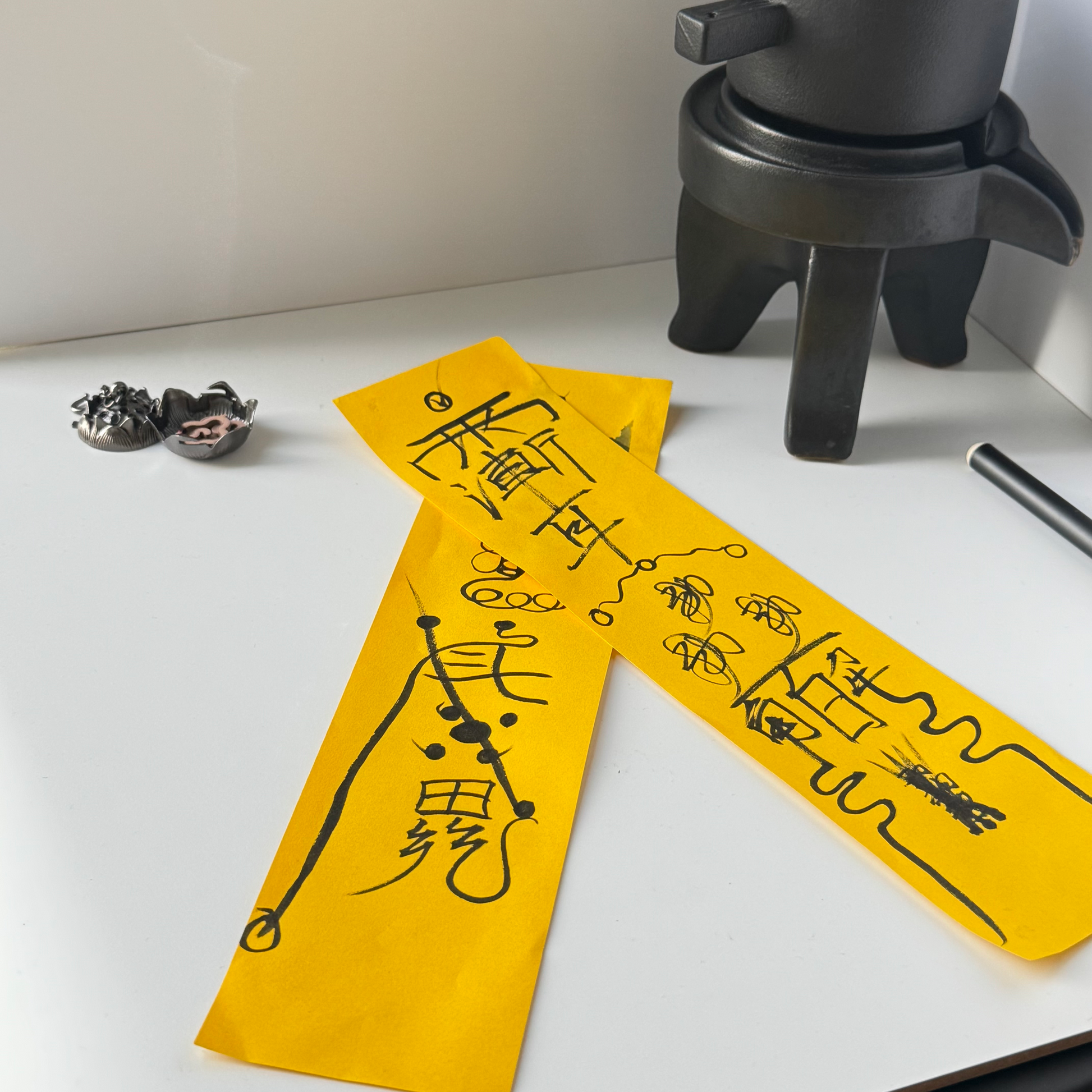 Hand-drawn Taoist talismans on yellow ritual paper